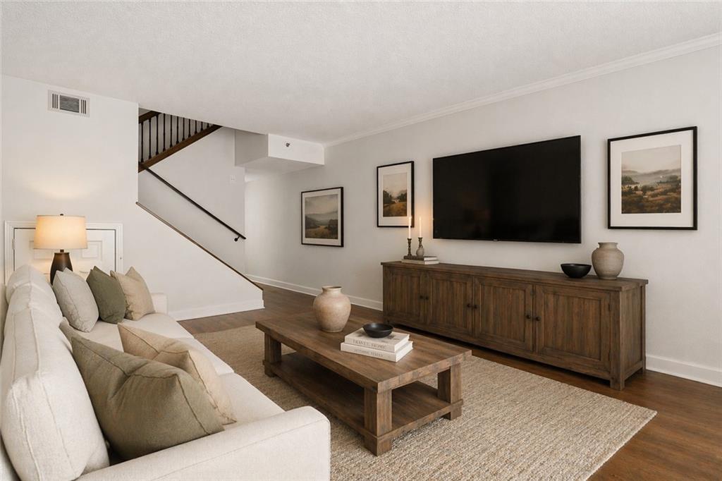 383 Ralph McGill Boulevard Northeast, Unit J Atlanta, GA 30312 - Photo 4 of 33 a living room with furniture and a flat screen tv