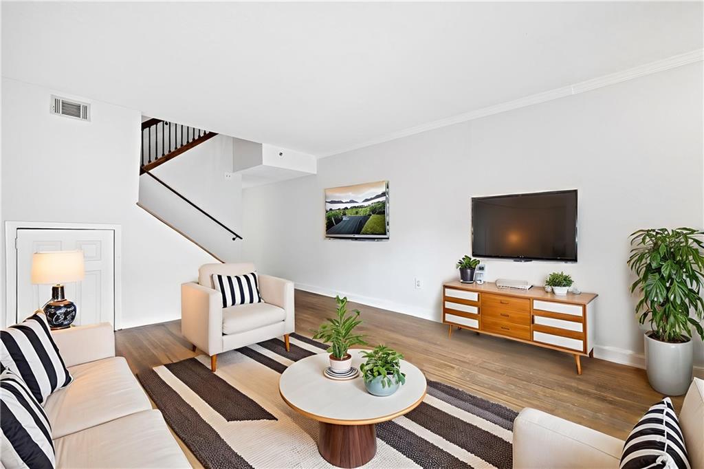 383 Ralph McGill Boulevard Northeast, Unit J Atlanta, GA 30312 - Photo 4 of 28 a living room with furniture and a flat screen tv