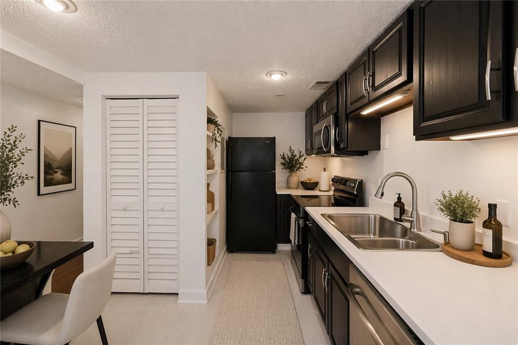 383 Ralph McGill Boulevard Northeast, Unit J Atlanta, GA 30312 - Photo 10 of 33 a kitchen with stainless steel appliances granite countertop a sink stove and refrigerator