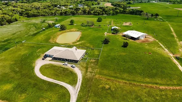 an aerial view of a residential houses with outdoor space and swimming pool