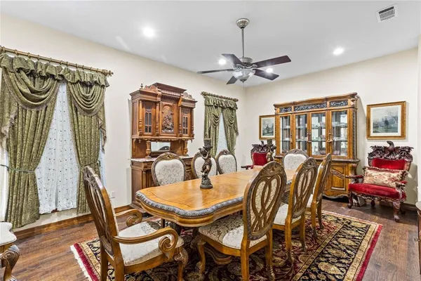 a dinning room with chairs and wooden floor