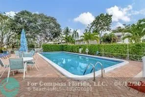 a view of a house with backyard porch and sitting area