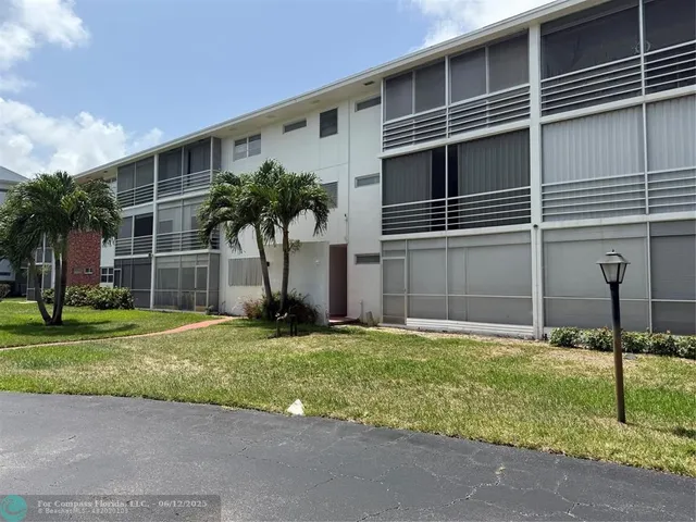 a house with a yard and a large parking space