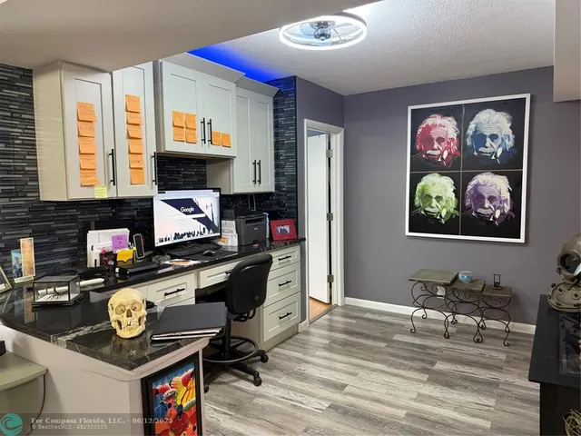 a kitchen with stainless steel appliances kitchen island granite countertop a stove and a refrigerator