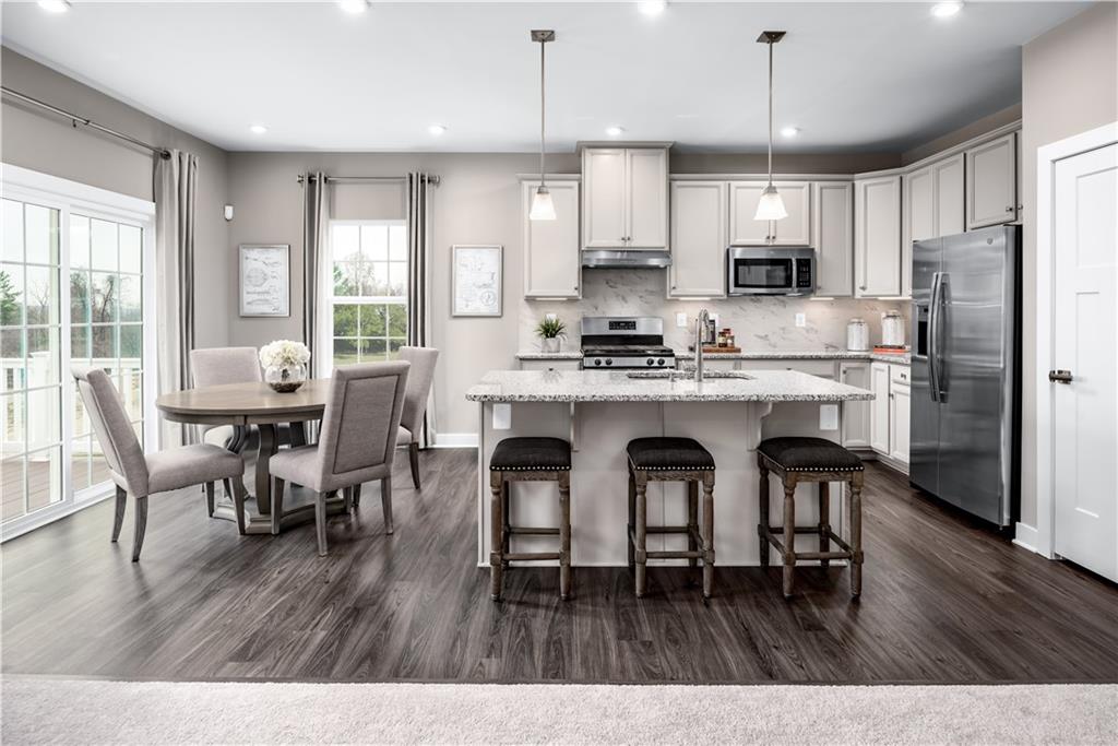 348 Dana Drive Eighty Four, PA 15330 - Photo 2 of 5 a open kitchen with stainless steel appliances granite countertop a dining table chairs refrigerator microwave and cabinets