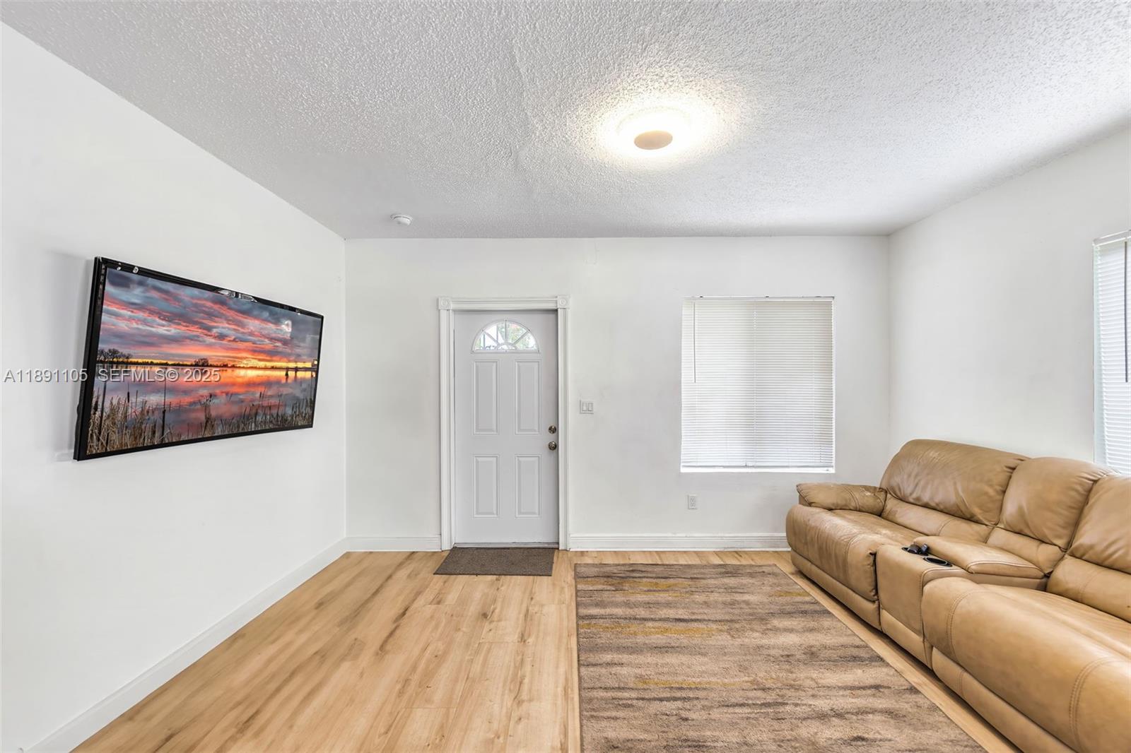110 Northeast 9th Court Homestead, FL 33030 - Photo 14 of 26 a living room with furniture and a wooden floor