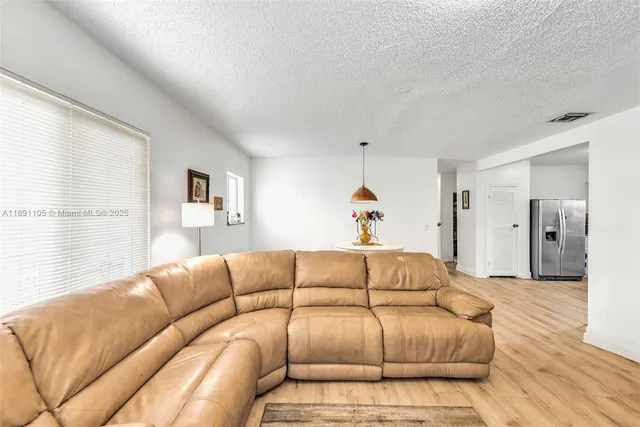 a living room with a couch and a wooden floor