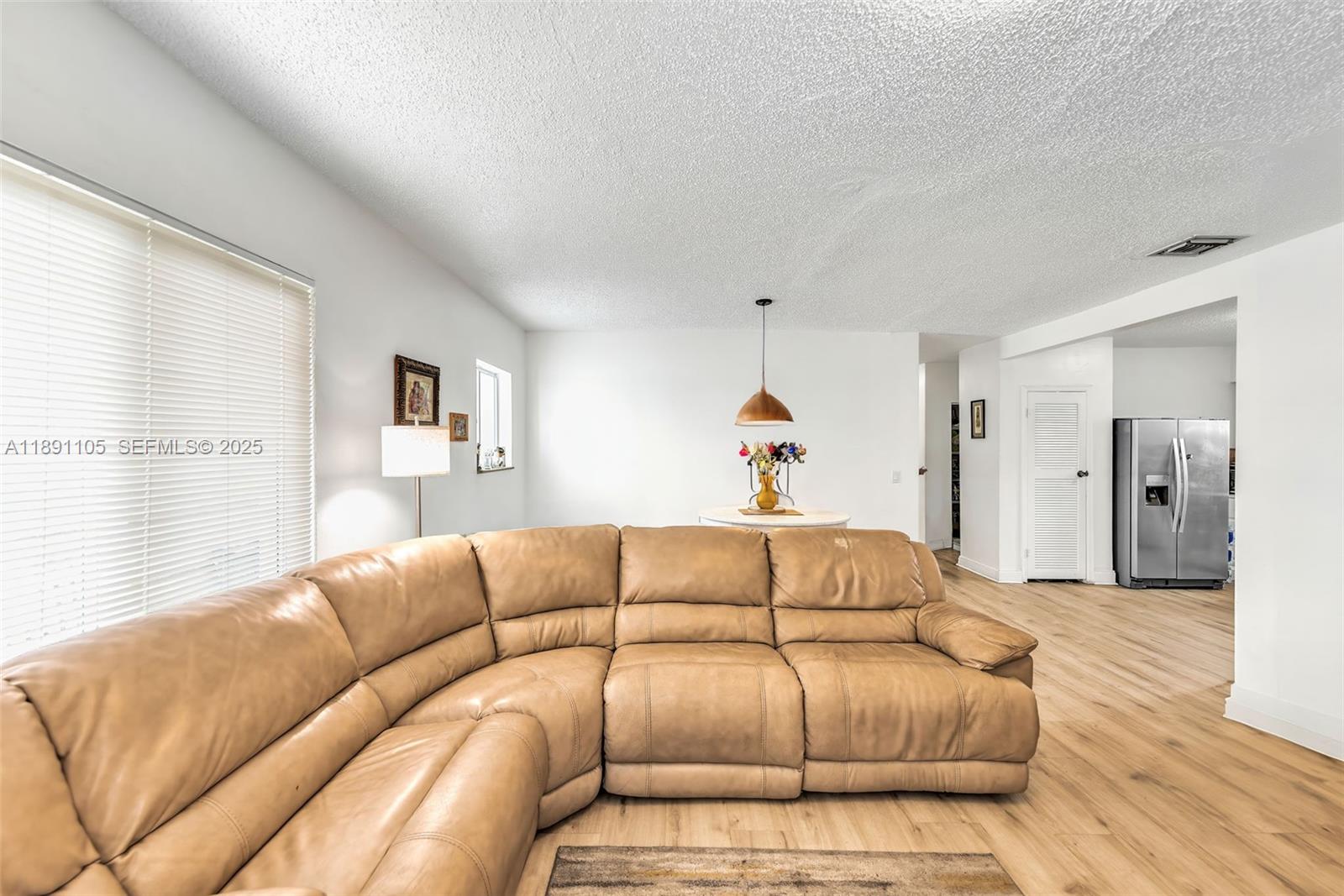 110 Northeast 9th Court Homestead, FL 33030 - Photo 15 of 26 a living room with a couch and a wooden floor