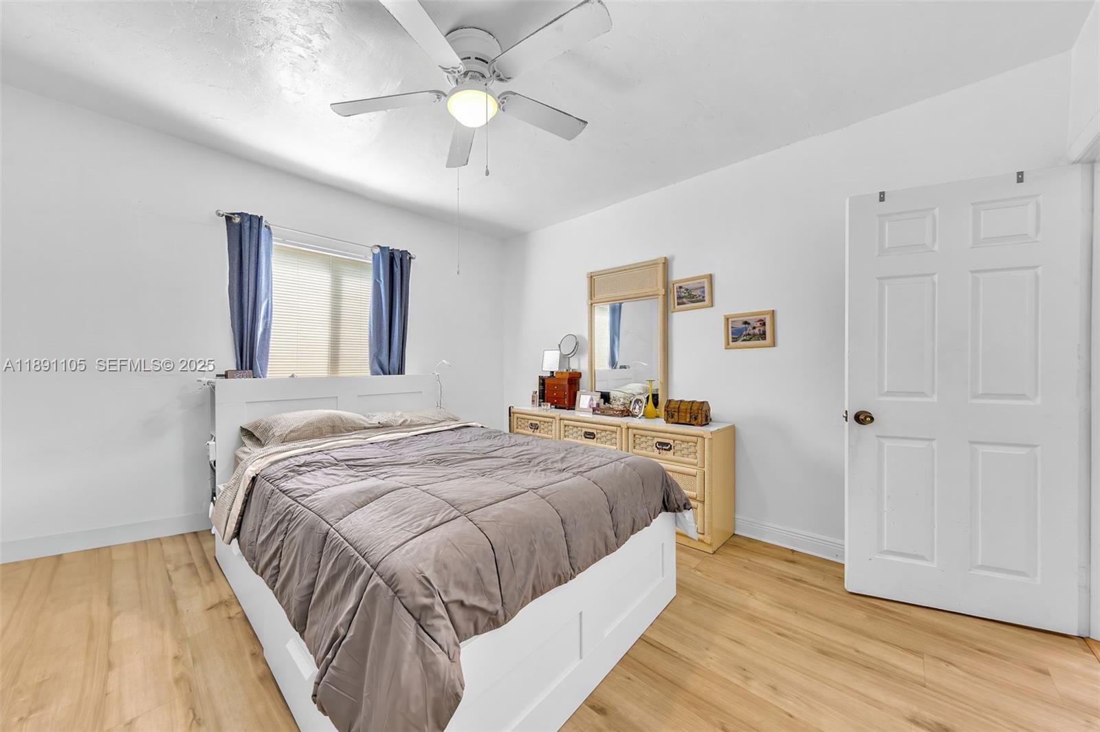 110 Northeast 9th Court Homestead, FL 33030 - Photo 16 of 26 a bed room with a bed and a chandelier