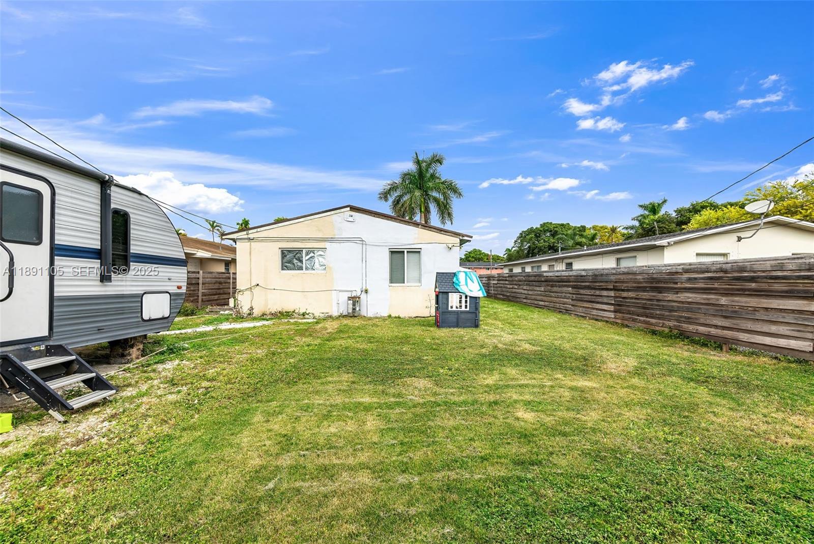 110 Northeast 9th Court Homestead, FL 33030 - Photo 24 of 26 a view of a backyard with plants and a patio