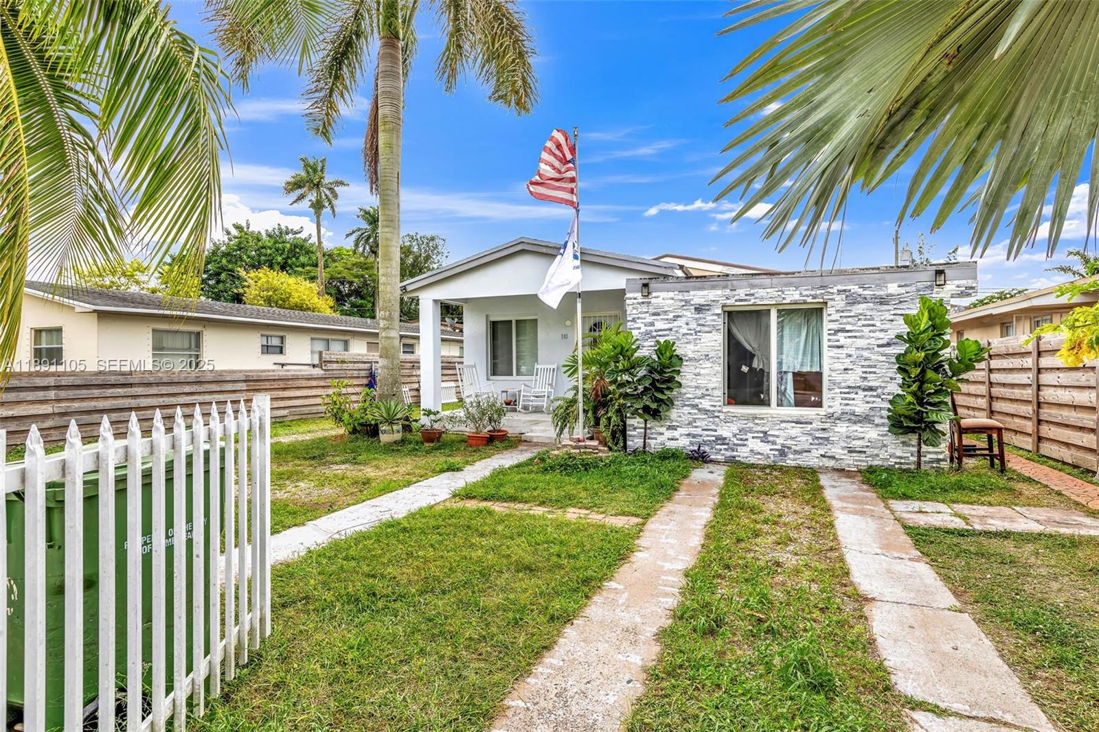 110 Northeast 9th Court Homestead, FL 33030 - Photo 3 of 26 a front view of a house with a yard table and chairs