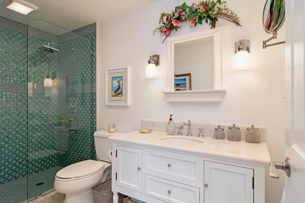a bathroom with a sink mirror vanity and toilet