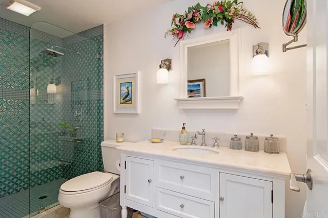 a bathroom with a sink mirror vanity and toilet