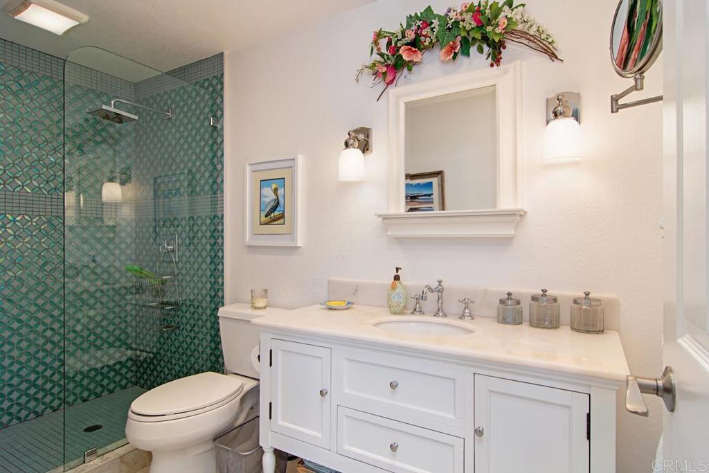 67 Tunapuna Lane Coronado, CA 92118 - Photo 11 of 13 a bathroom with a sink mirror vanity and toilet