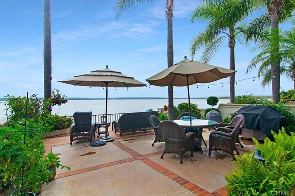 a view of backyard with outdoor seating and plants