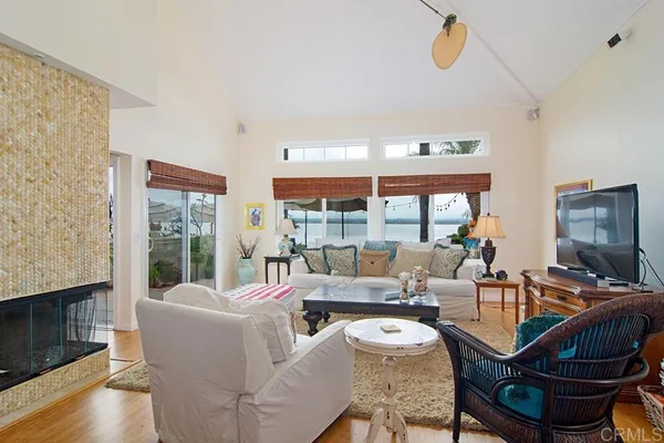 a living room with fireplace furniture and a floor to ceiling window