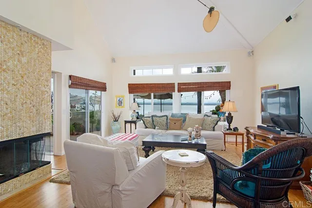 a living room with fireplace furniture and a floor to ceiling window