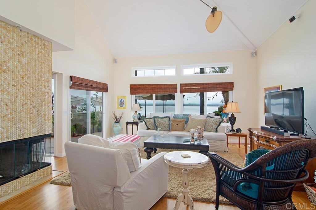 67 Tunapuna Lane Coronado, CA 92118 - Photo 2 of 13 a living room with fireplace furniture and a floor to ceiling window