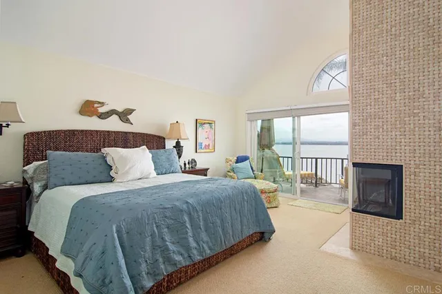 a bedroom with a balcony a bed and a couch with window