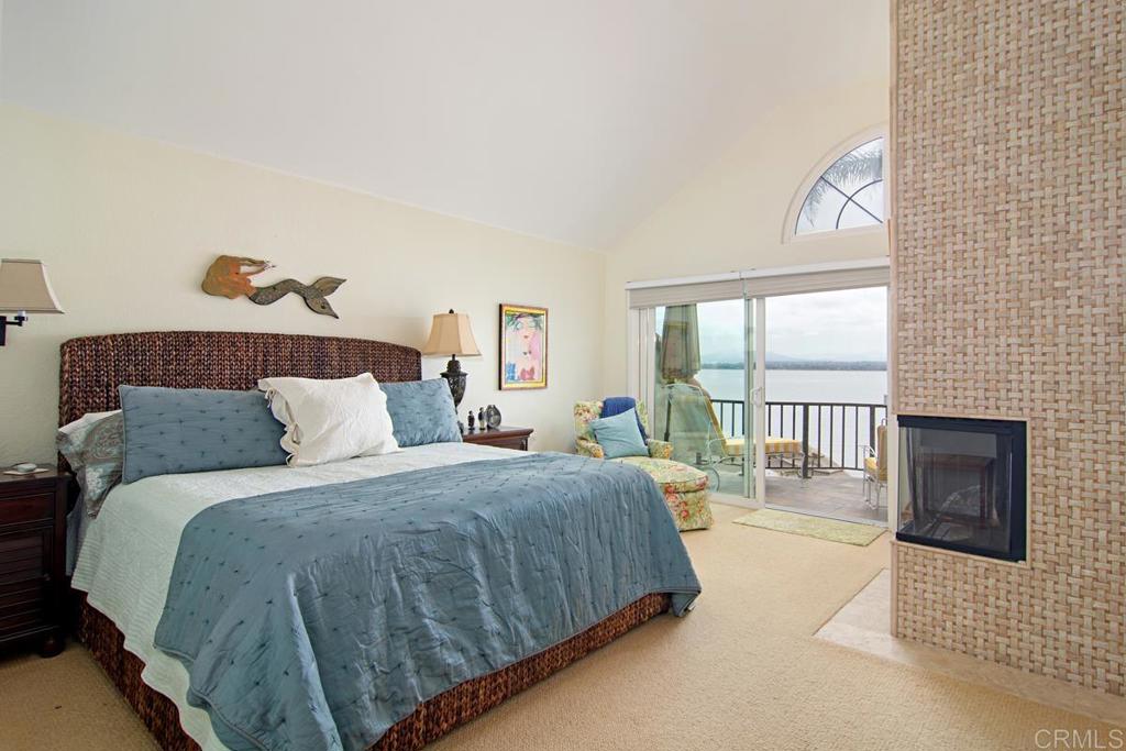 67 Tunapuna Lane Coronado, CA 92118 - Photo 8 of 13 a bedroom with a balcony a bed and a couch with window