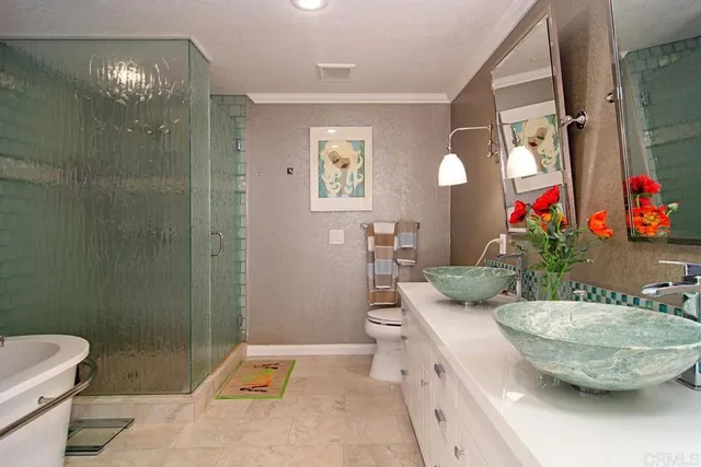 a view of bathroom with a toilet sink and mirror