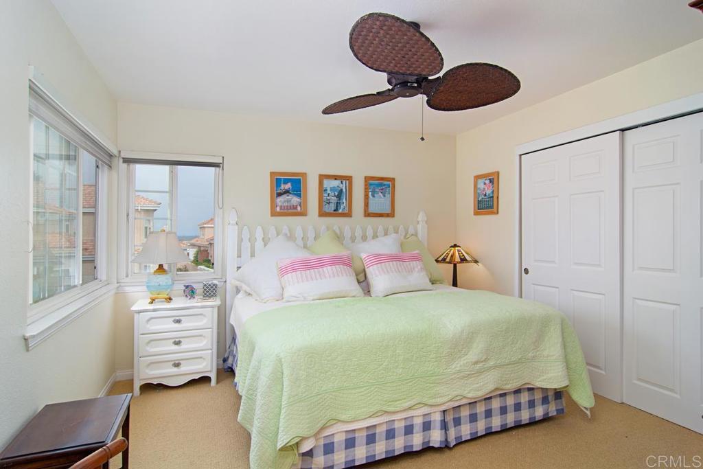 67 Tunapuna Lane Coronado, CA 92118 - Photo 10 of 13 a bedroom with a bed and a chandelier