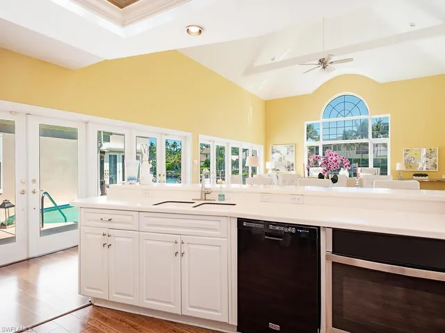 a view of kitchen with oven a sink and dishwasher a oven with wooden cabinets