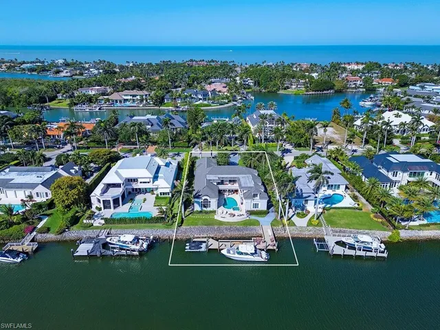 an aerial view of residential houses with outdoor space and swimming pool