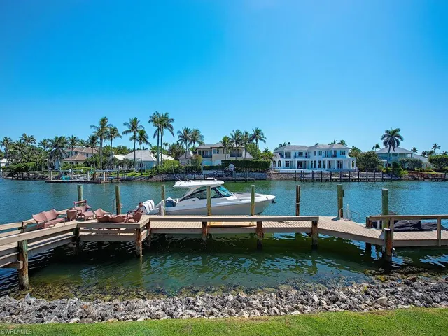 a view of a lake with lawn chairs