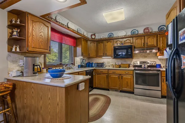 a dining room with furniture a chandelier and window