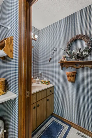 a bedroom with a bed and a flat tv screen on dresser