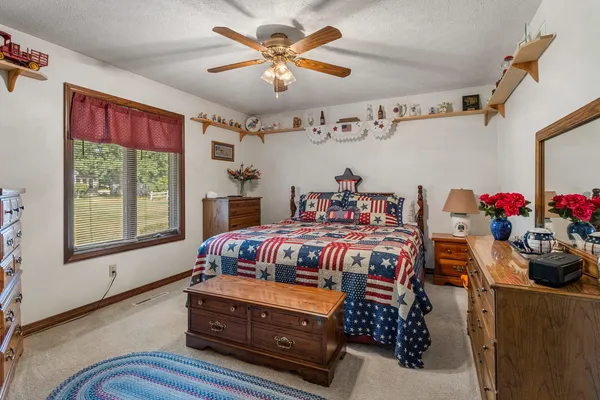 a bedroom with a bed and a dresser in it