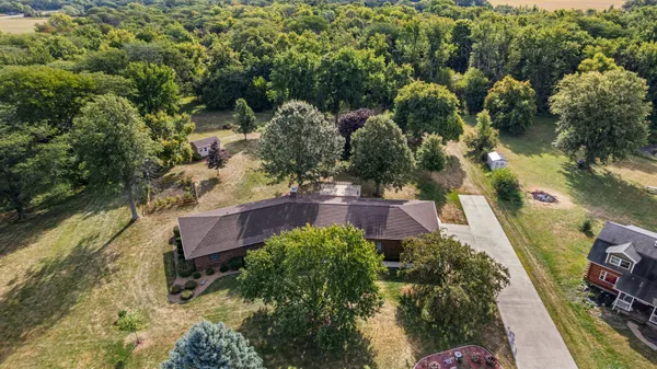 a swimming pool is sitting in a big yard with large trees