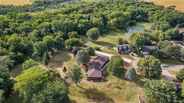 an aerial view of a house with a yard