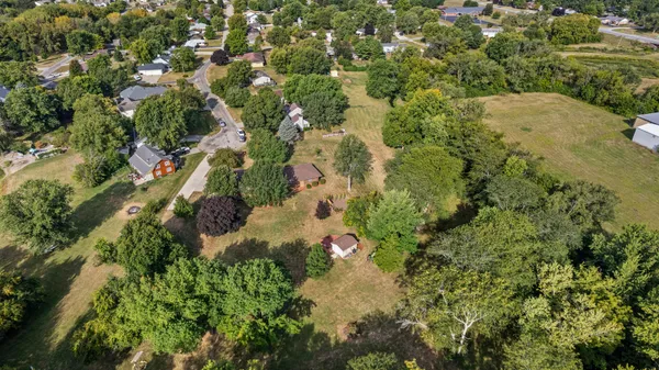 an aerial view of a house with a yard