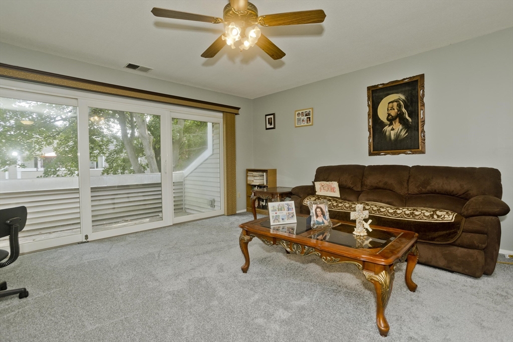 65 Nassau Drive, Unit 65 Springfield, MA 01129 - Photo 11 of 32 a living room with furniture and a window
