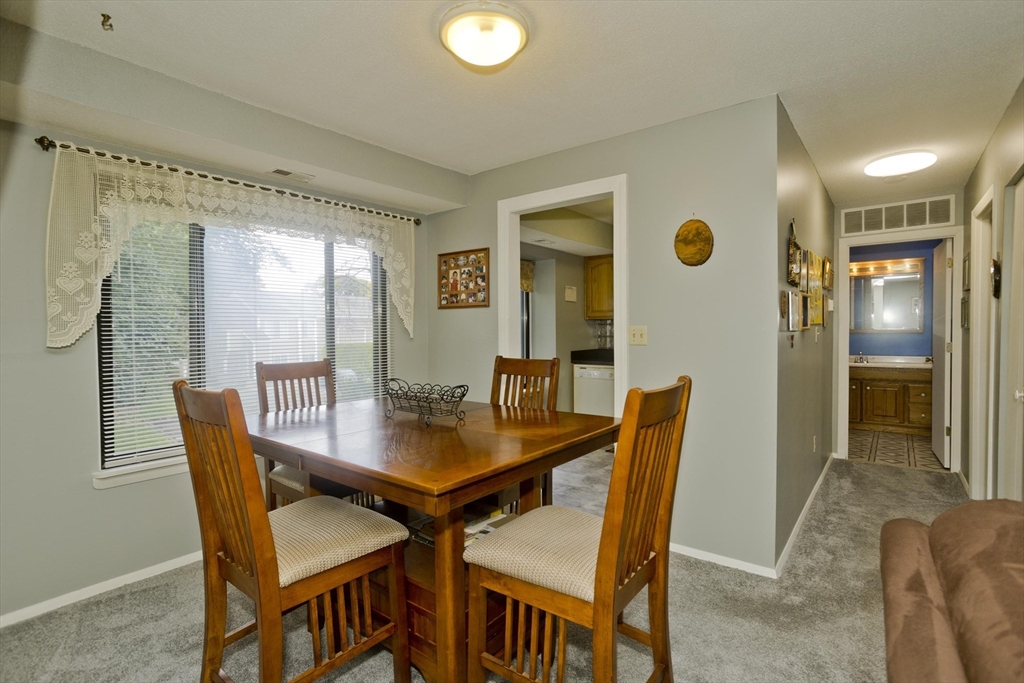 65 Nassau Drive, Unit 65 Springfield, MA 01129 - Photo 13 of 32 a view of a dining room with furniture and window