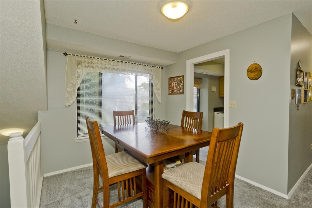 65 Nassau Drive, Unit 65 Springfield, MA 01129 - Photo 14 of 32 a view of a dining room with furniture and window