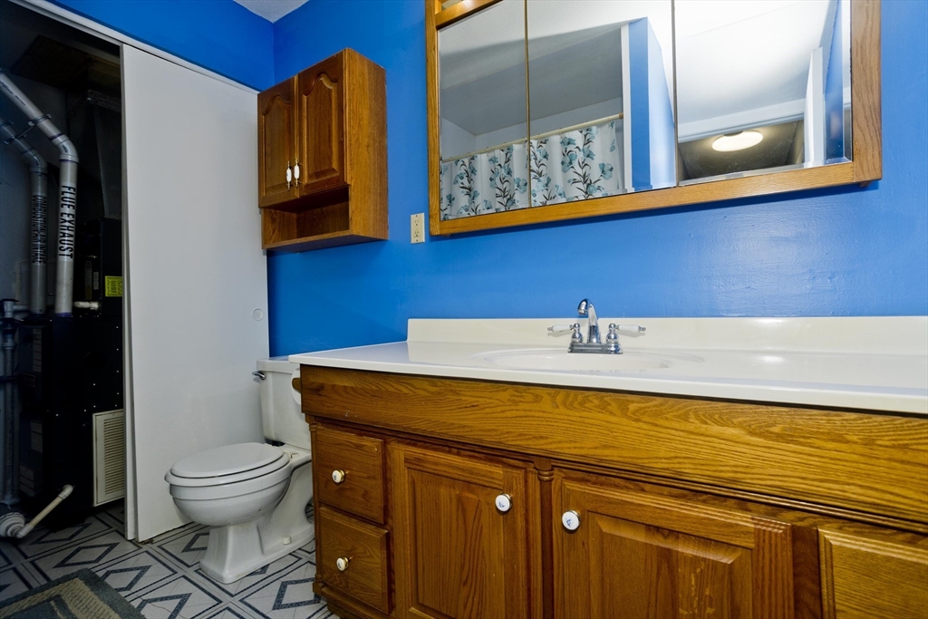 65 Nassau Drive, Unit 65 Springfield, MA 01129 - Photo 18 of 32 a bathroom with a toilet a sink and mirror