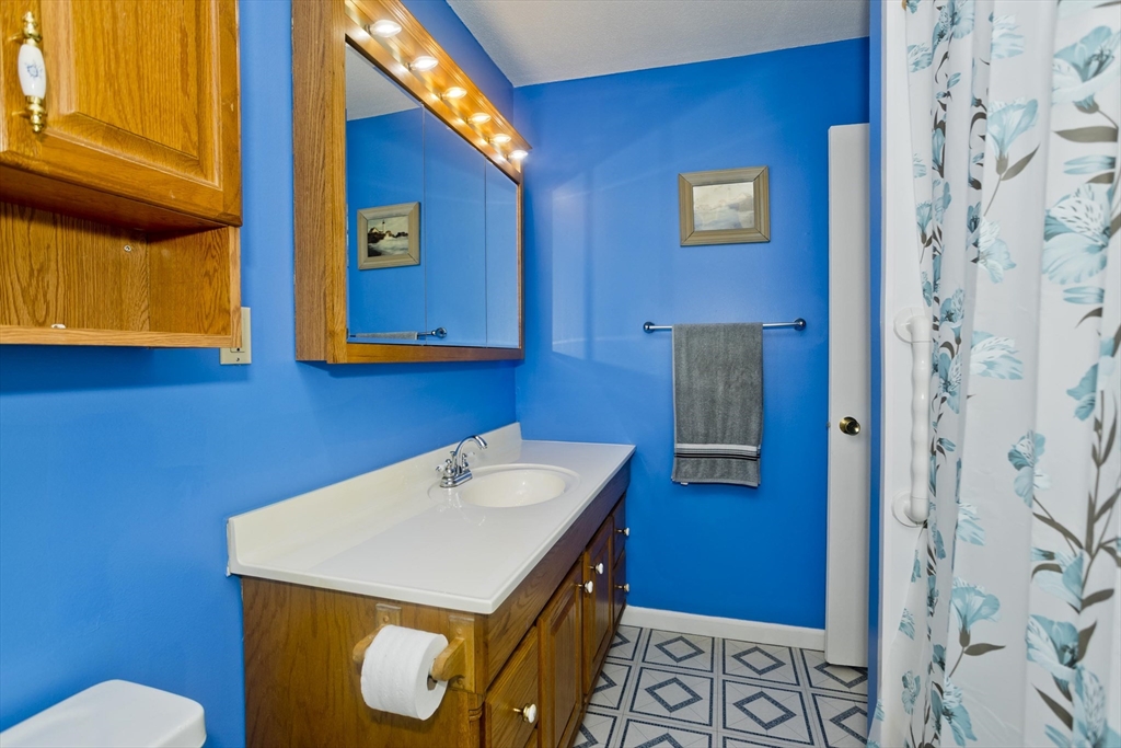 65 Nassau Drive, Unit 65 Springfield, MA 01129 - Photo 20 of 32 a bathroom with a sink and a mirror