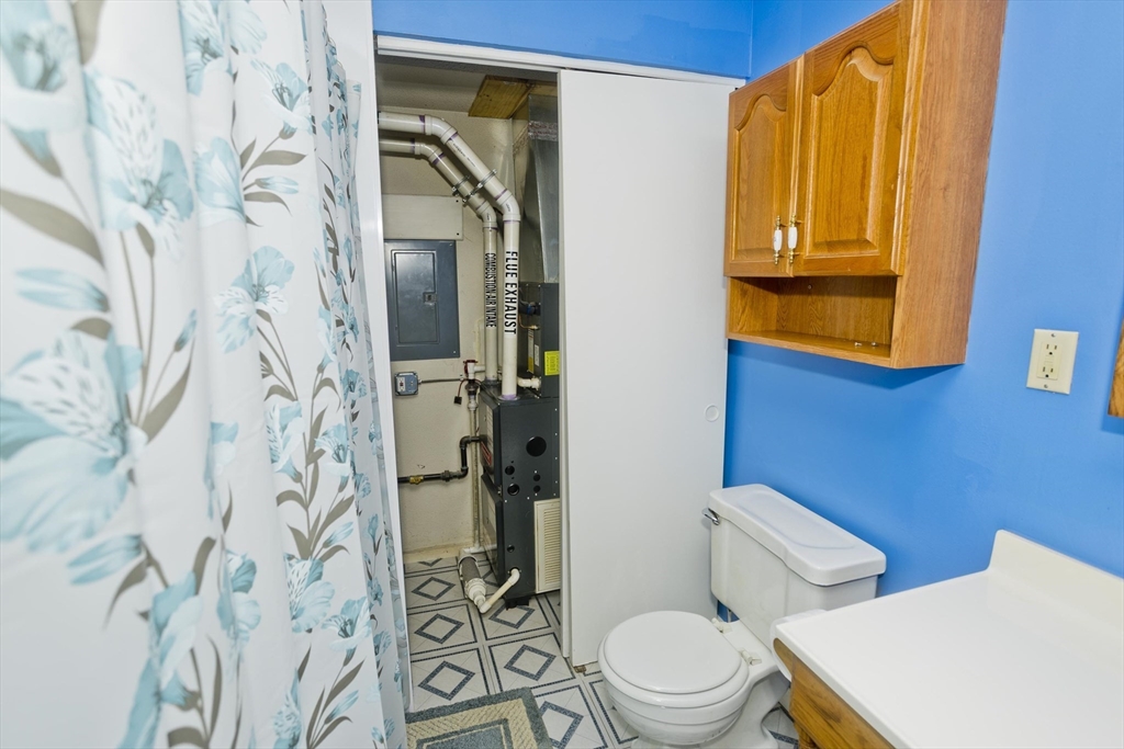 65 Nassau Drive, Unit 65 Springfield, MA 01129 - Photo 21 of 32 a white toilet sitting next to a shower curtain