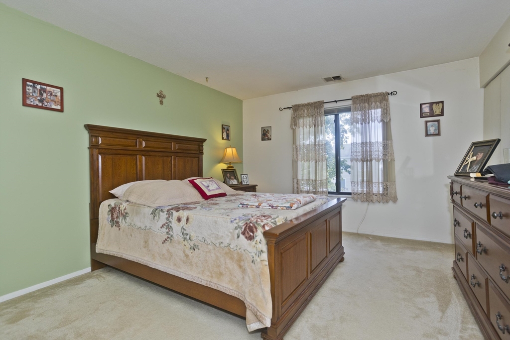 65 Nassau Drive, Unit 65 Springfield, MA 01129 - Photo 25 of 32 a bedroom with a bed and a window