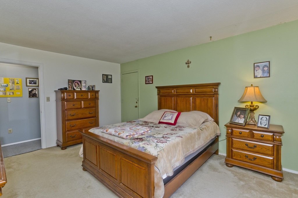 65 Nassau Drive, Unit 65 Springfield, MA 01129 - Photo 26 of 32 a bedroom with a bed and a dresser