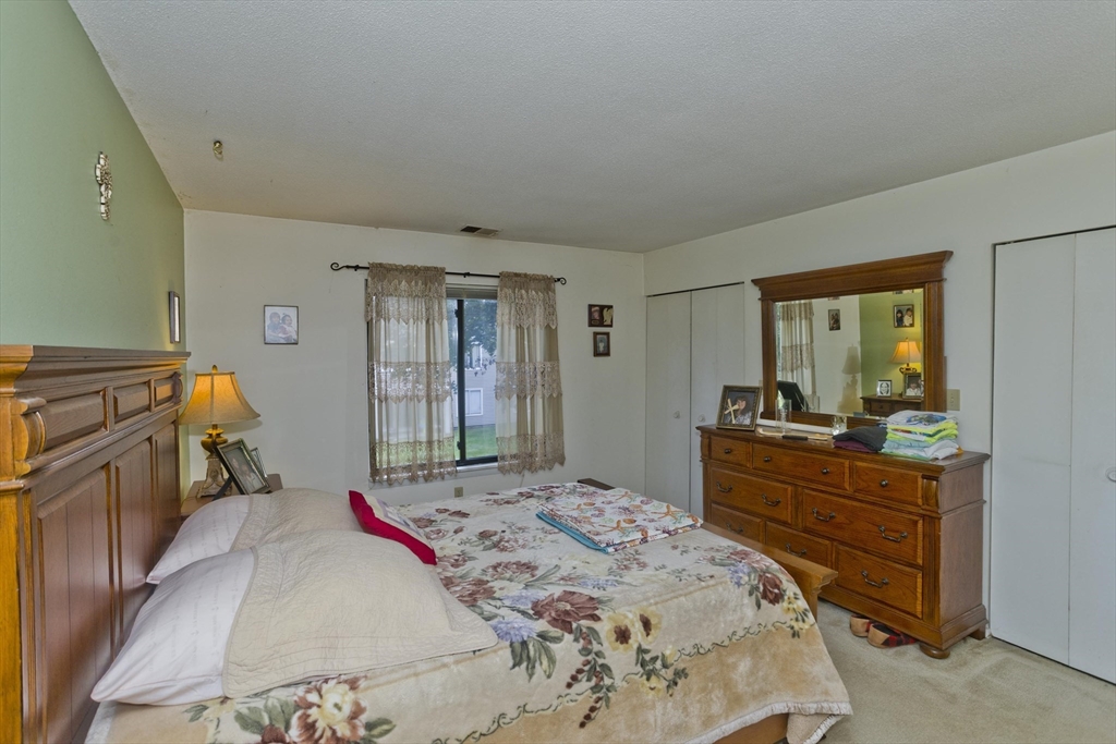 65 Nassau Drive, Unit 65 Springfield, MA 01129 - Photo 27 of 32 a bed room with a bed and a dresser