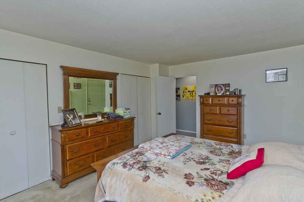 65 Nassau Drive, Unit 65 Springfield, MA 01129 - Photo 28 of 32 a bedroom with a bed and wooden floor