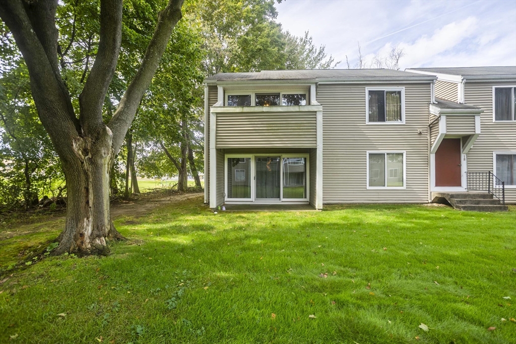 65 Nassau Drive, Unit 65 Springfield, MA 01129 - Photo 3 of 32 a front view of a house with a garden