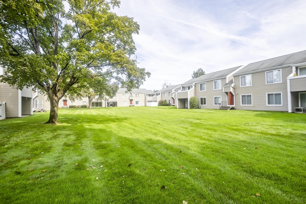 65 Nassau Drive, Unit 65 Springfield, MA 01129 - Photo 4 of 32 a house view with a sitting space and garden view