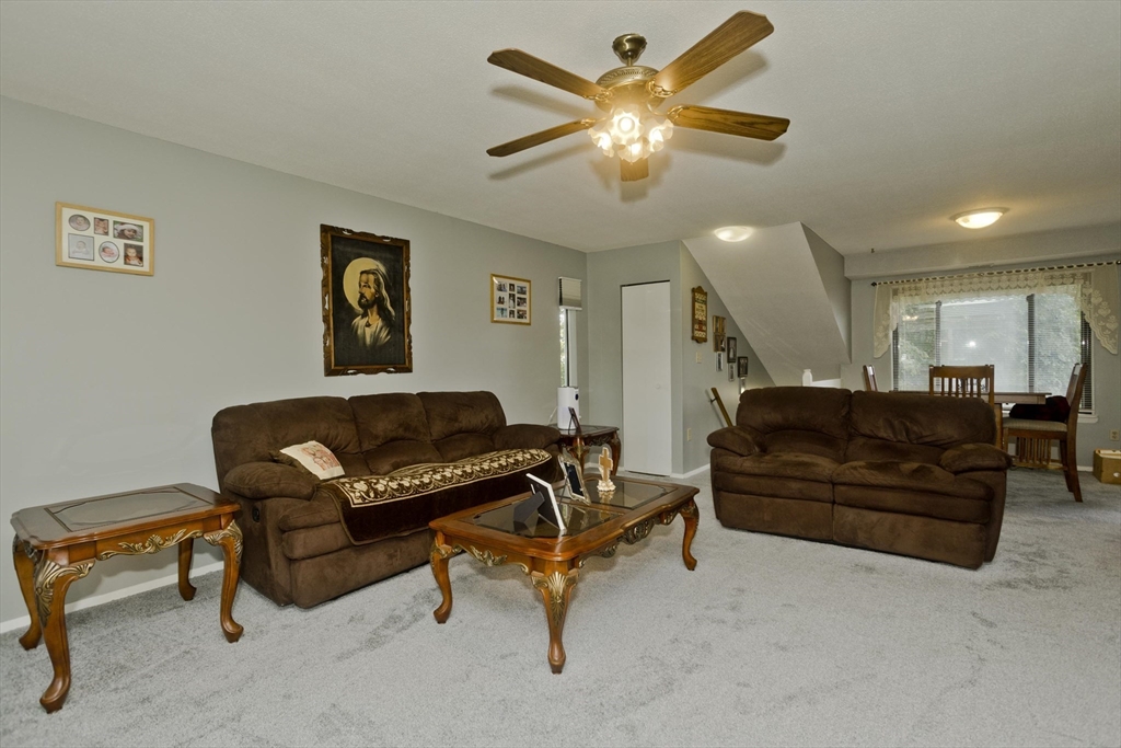 65 Nassau Drive, Unit 65 Springfield, MA 01129 - Photo 9 of 32 a living room with furniture and a potted plant