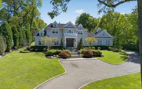 a front view of a house with a garden and porch