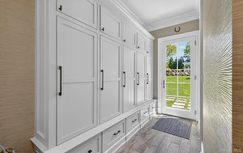 a view of an entryway with wooden floor